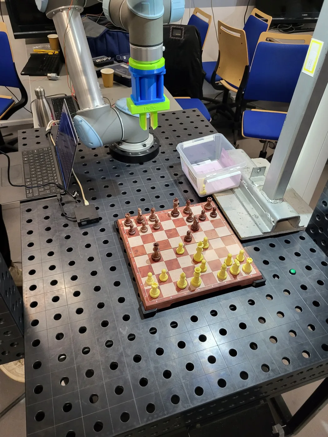 UR5 chess robot with a custom gripper beside a chessboard